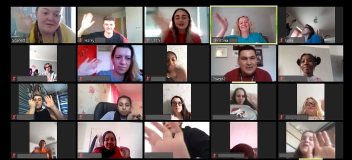 Image of 20 smiling faces on Zoom call